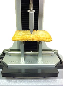 Texture analyzer testing breakfast strudel pastry for crispiness